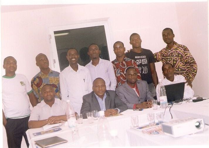 The early volunteer team posing together around a meeting table